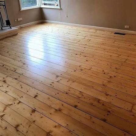 Baltic Pine, distinctively knotty — small round dark knots scattered through pale wood — with a soft, resinous look